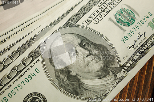 Image of Bundle of money on wooden background