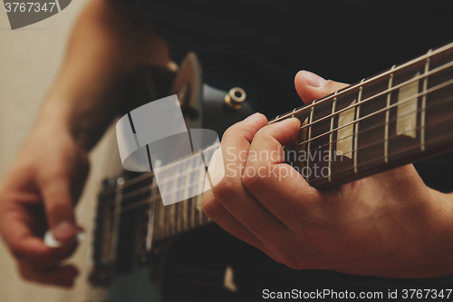 Image of Man playing on guitar