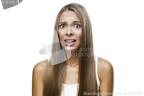 Image of Portrait of frowned woman on white background