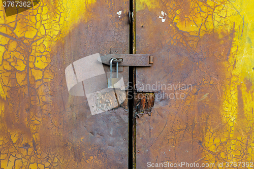 Image of Background of door with lock in metal material 