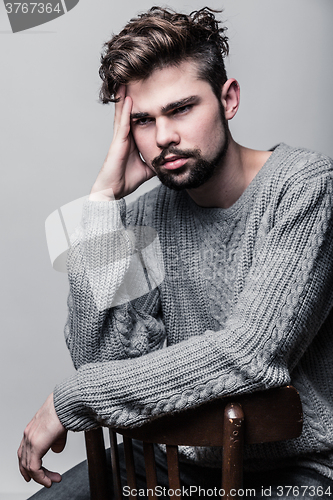 Image of Portrait of a young man in gray pullover