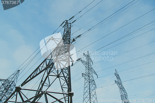 Image of Big frosty power lines among winter.