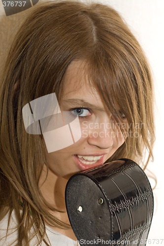Image of Portrait of the nice girl playing with a belt