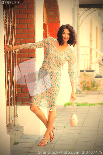 Image of smiling middle-aged woman in a summer dress