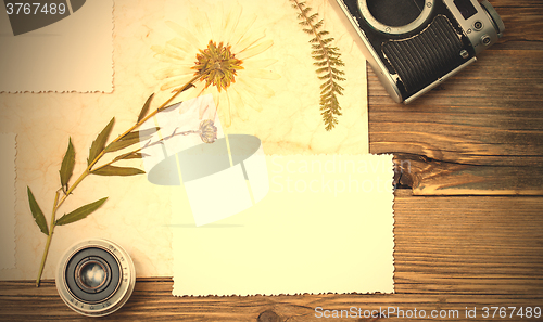 Image of still life with copy space photo, lens, retro camera and pressed