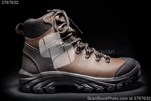 Image of New hiking boot. Isolated on black
