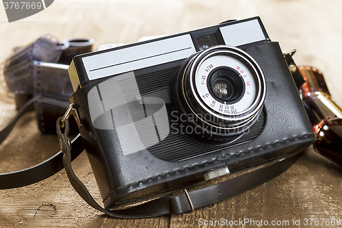 Image of Vintage photo camera and blank film strip 