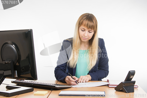 Image of Office worker enthusiastically studying a paper document