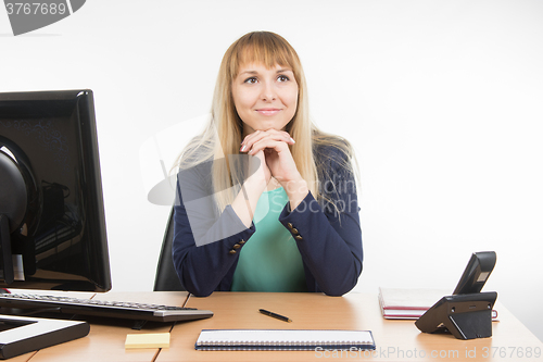 Image of The secretary looks at the visitor office