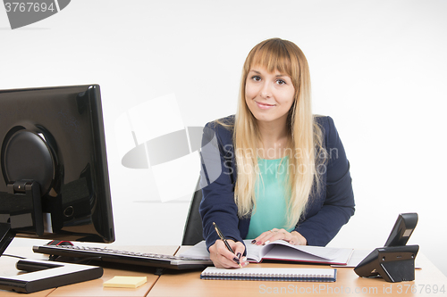 Image of Business woman writing a note in the diary