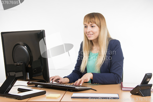 Image of Business woman working at the computer in the office