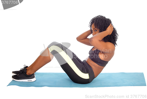 Image of African American woman doing sit-up\'s.