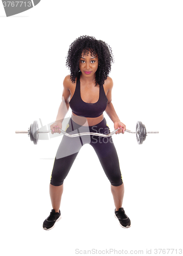 Image of African American woman weight lifting.