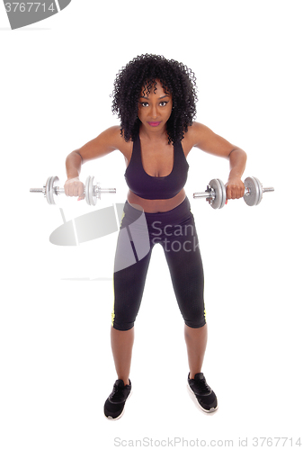 Image of African American woman with dumbbell\'s.