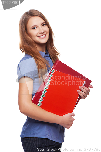 Image of Young woman holding textbooks