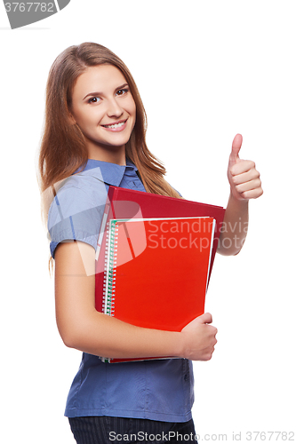 Image of Young woman holding textbooks