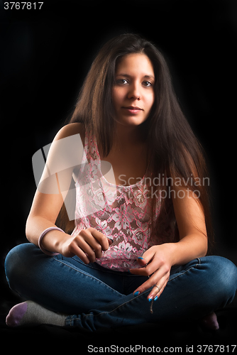 Image of Attractive sad woman on floor