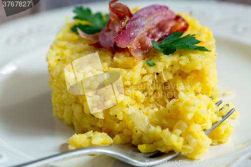 Image of Portion of risotto with bacon and parsley.