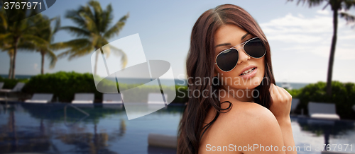 Image of young woman with sunglasses on beach