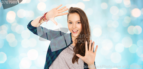 Image of happy smiling pretty teenage girl showing hands