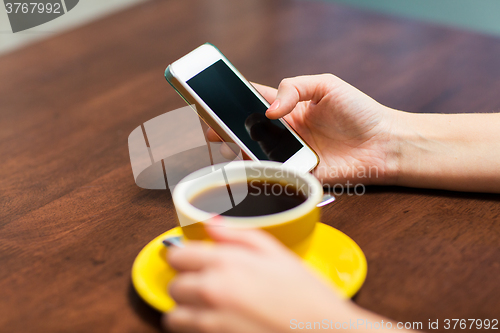 Image of close up of woman with smartphone and coffee