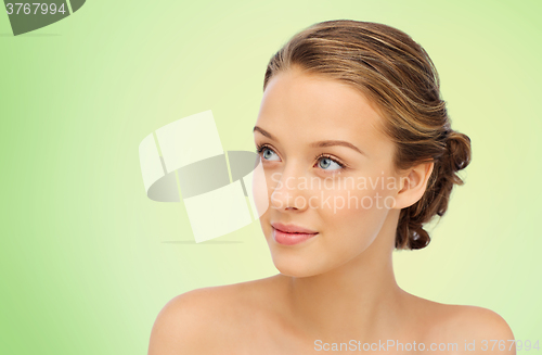 Image of smiling young woman face and shoulders