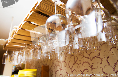 Image of wine glasses hanging upside down on bar holder