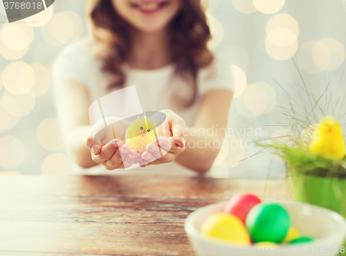 Image of close up of girl holding easter chicken toy