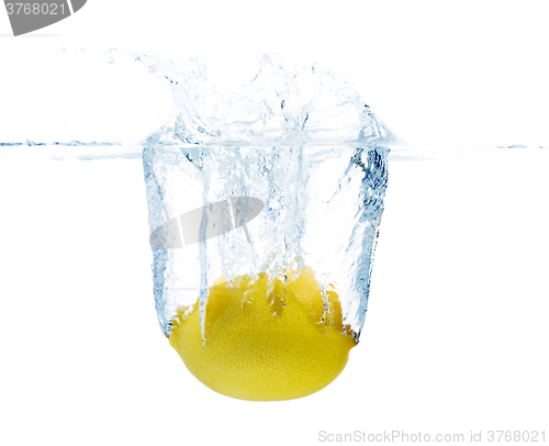 Image of lemon falling or dipping in water with splash