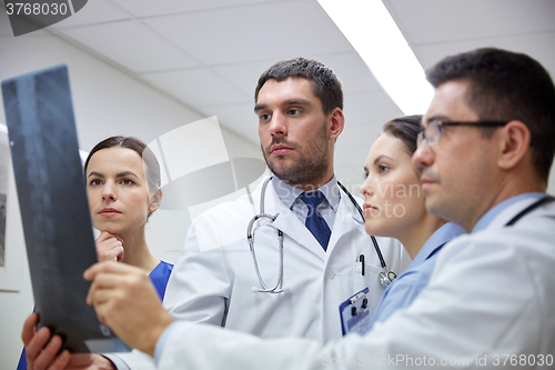 Image of group of doctors looking at x-ray scan image