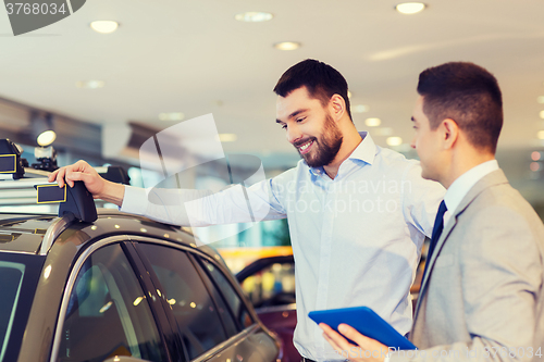 Image of happy man with car dealer in auto show or salon