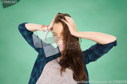 Image of happy student teenage girl holding to head