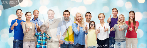 Image of happy people with shopping bags showing thumbs up