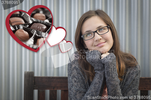Image of Daydreaming Girl Next To Floating Hearts with Chocolates