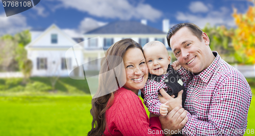 Image of Young Family With Baby Outdoors In Front of Custom Home