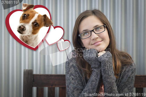 Image of Daydreaming Girl Next To Floating Hearts with Puppy Within