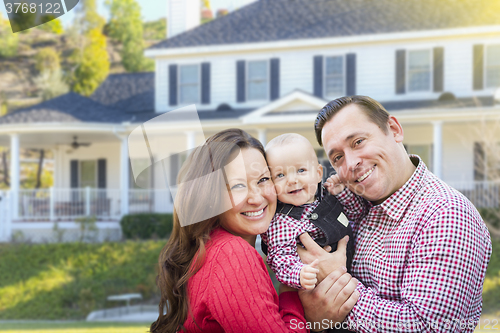 Image of Young Family With Baby Outdoors In Front of Custom Home