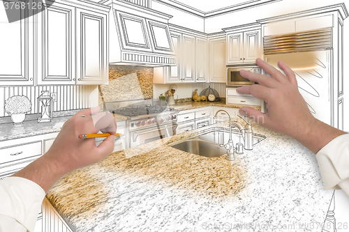 Image of Male Hands Sketching Custom Kitchen with Photo Showing Through