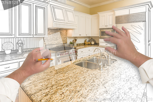 Image of Male Hands Sketching Custom Kitchen with Photo Showing Through