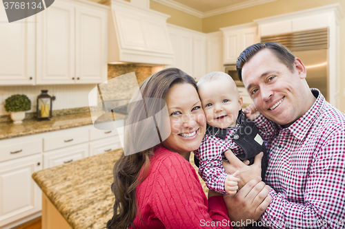 Image of Young Family Inside Beautiful Custom Kitchen