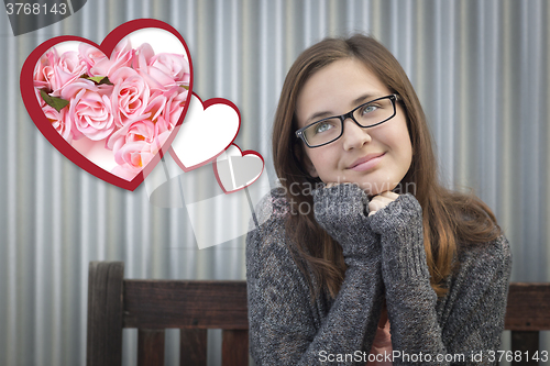 Image of Daydreaming Girl Next To Floating Hearts with Pink Roses