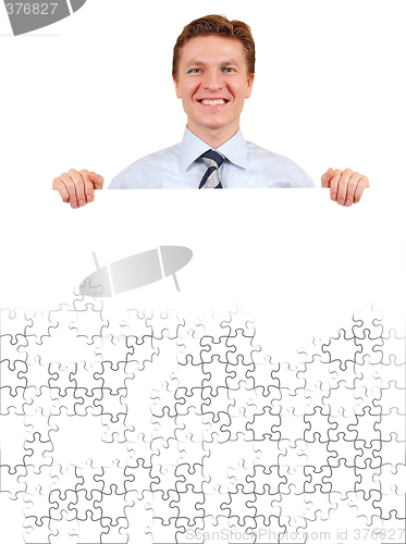 Image of Confident business man holding a white puzzle board for copy-spa