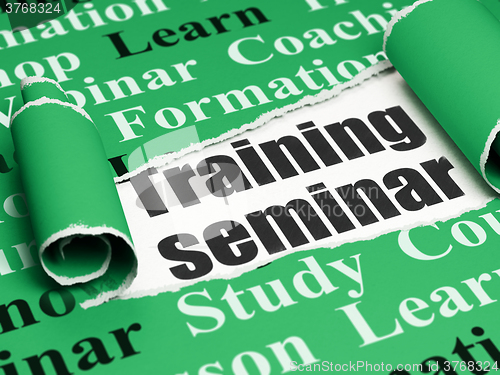 Image of Studying concept: black text Training Seminar under the piece of  torn paper