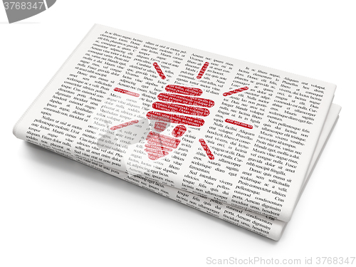Image of Finance concept: Energy Saving Lamp on Newspaper background
