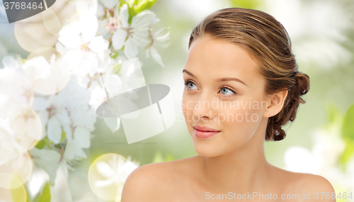 Image of smiling young woman face and shoulders