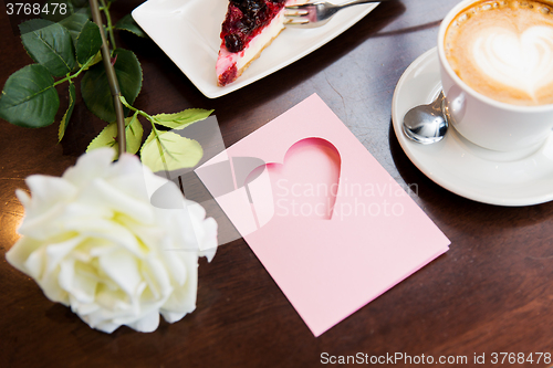 Image of close up of greeting card with heart and coffee