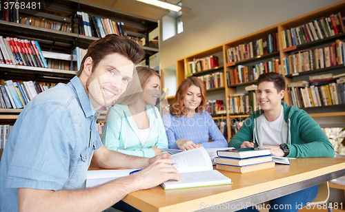 Image of students with books preparing to exam in library