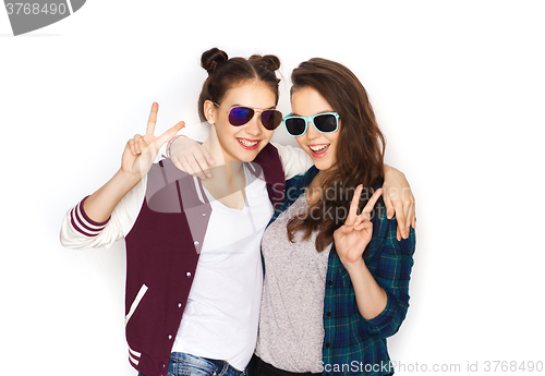 Image of smiling teenage girls in sunglasses showing peace