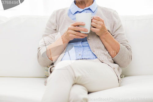 Image of close up of senior woman with tea cup at home