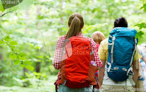 Image of close up of friends with backpacks hiking